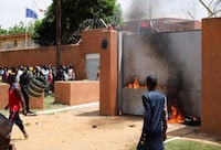 Pro-junta demonstrators gathered outside the French embassy, try to set it on fire before being dispersed by Nigerian security forces in Niamey, the capital city of Niger July 30, 2023. REUTERS/Souleymane Ag Anara