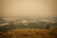 Smoke from wildfires fills the air in Kelowna, B.C., Saturday, Aug. 19, 2023. The Transportation Safety Board of Canada is warning about the risks of fires going unnoticed on locomotives, citing dozens of blazes in a report into an incident that triggered a wildfire two years ago in southeast British Columbia. THE CANADIAN PRESS/Darryl Dyck