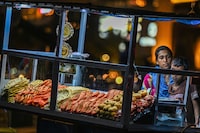 A street vendor sells prawns and sea-food at her kiosk at the Galle Face Beach in Colombo on March 20, 2023. - Cash-strapped Sri Lanka is seeking a 10-year moratorium on its foreign debt, President Ranil Wickremesinghe's office said on March 20 on the eve of a desperately needed $2.9 billion IMF bailout. (Photo by ISHARA S. KODIKARA / AFP) (Photo by ISHARA S. KODIKARA/AFP via Getty Images)
