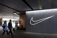 FILE PHOTO: People walk past a store of the sporting goods retailer Nike Inc at a shopping complex in Beijing, China March 25, 2021. REUTERS/Florence Lo/File Photo