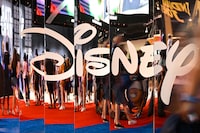 (FILES) In this file photo taken on September 09, 2022 attendees are reflected in Disney+ logo during the Walt Disney D23 Expo in Anaheim, California. - Disney's streaming service saw its first ever fall in subscribers last quarter, company data showed on February 8, 2023, as consumers cut back on spending amid higher costs and a souring global economy. Disney CEO Bob Iger on February 8, 2023, announced that the company would lay off 7,000 workers, in the veteran executive's first major decision since returning to lead the company in November. (Photo by Patrick T. FALLON / AFP) (Photo by PATRICK T. FALLON/AFP via Getty Images)