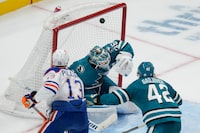 San Jose Sharks goaltender Kaapo Kahkonen, middle, is unable to stop a goal by Edmonton Oilers right wing Jesse Puljujarvi (13) during the third period of an NHL hockey game in San Jose, Calif., Friday, Jan. 13, 2023. (AP Photo/Godofredo A. Vásquez)