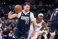 Dallas Mavericks guard Luka Doncic, left, dries toward the basket as Los Angeles Clippers guard Brandon Boston Jr. follows during the second half in Game 5 of an NBA basketball first-round playoff series Wednesday, May 1, 2024, in Los Angeles. (AP Photo/Mark J. Terrill)