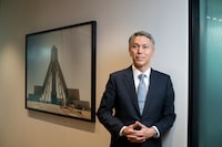 Mike Henry, CEO of Australian mining company BHP, standing beside a photograph of the company’s Jansen potash project, located in Saskatchewan, Canada, is photographed  on Oct 17, 2023. (Fred Lum/The Globe and Mail)