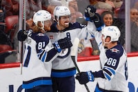 SUNRISE, FL - MARCH 11: Mark Scheifele #55 celebrates his overtime game winning goal with Kyle Connor #81 and Nate Schmidt #88 of the Winnipeg Jets against the Florida Panthers at the FLA Live Arena on March 11, 2023 in Sunrise, Florida. (Photo by Joel Auerbach/Getty Images)