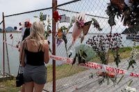 FILE PHOTO: People look at a memorial at the harbour in Whakatane, following the White Island volcano eruption in New Zealand, December 11, 2019. REUTERS/Jorge Silva/File Photo