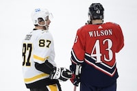 FILE - Pittsburgh Penguins center Sidney Crosby (87) talks with Washington Capitals right wing Tom Wilson (43) during the second period of an NHL hockey game, Feb. 23, 2021, in Washington. After lengthy playoff streaks ended, the Penguins and Capitals are making moves to get back in the mix now. The Capitals re-signed Wilson for $45.5 million over seven years. Wilson turns 30 before his new deal starts. The deal doesn’t make Washington any younger, and it's a significant gambles for an older team that has won the Stanley Cup and are trying to keep contending. Penguins captain Sidney Crosby celebrated his 36th birthday Monday, and Capitals counterpart and longtime rival Alex Ovechkin turns 38 next month. (AP Photo/Nick Wass, file)