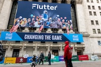 People walk by a banner  outside of the New York Stock Exchange (NYSE) for the IPO of Flutter Entertainment, the parent company of FanDuel, on Jan. 29 in New York City.