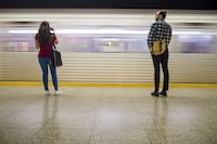 Rogers Communications Inc. says it has turned on wireless service for its own customers at all TTC subway stations, plus the tunnels between Sheppard West and Vaughan Metropolitan Centre stations. Commuters wait to take the subway at Ossington Station in Toronto on Friday, June 22, 2018. THE CANADIAN PRESS/ Tijana Martin