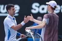 Italy's Jannik Sinner greets Serbia's Novak Djokovic (L) after victory in their men's singles semi-final match on day 13 of the Australian Open tennis tournament in Melbourne on January 26, 2024. (Photo by Martin KEEP / AFP) / -- IMAGE RESTRICTED TO EDITORIAL USE - STRICTLY NO COMMERCIAL USE -- (Photo by MARTIN KEEP/AFP via Getty Images)