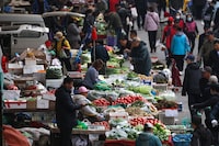 People buy vegetables at a market in Shenyang, in northeastern China's Liaoning province on April 11, 2024. (Photo by AFP) / China OUT (Photo by STR/AFP via Getty Images)