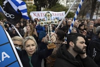 A protester raises a crucifix during a rally against same-sex marriage, at central Syntagma square, in Athens, Greece, Sunday, Feb. 11, 2024. More than 1,500 protesters have gathered in central Athens to oppose legislation that would legalize same-sex marriage in Greece. The bill is set for a vote in parliament in days. (AP Photo/Yorgos Karahalis)