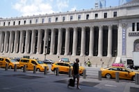 FILE PHOTO: Taxis are parked across the street from the U.S. Postal Service Farley building that Facebook announced it would lease for office space in the Manhattan borough of New York City, New York, U.S., August 5, 2020. REUTERS/Carlo Allegri/File Photo