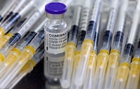 FILE PHOTO: A vial of Biontech-Pfizer's Comirnaty vaccine against COVID-19 and syringes are seen during vaccination at the Institute for Health and Food Safety of Zenica, Bosnia and Herzegovina, December 16, 2021. REUTERS/Dado Ruvic/File Photo