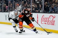 Anaheim Ducks defenseman Ilya Lyubushkin, right, and Los Angeles Kings right wing Quinton Byfield vie for the puck during the third period of an NHL hockey game Saturday, Feb. 24, 2024, in Los Angeles. (AP Photo/Ryan Sun)