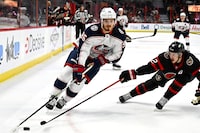 Columbus Blue Jackets centre Jack Roslovic (96) skates with the puck as Ottawa Senators defenceman Thomas Chabot (72) defends, during first period NHL hockey action in Ottawa, on Tuesday, Jan. 3, 2023. THE CANADIAN PRESS/Justin Tang