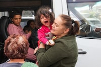 Refugees board a bus as they leave the Red Cross registration center, in Goris, on September 25, 2023. The first group of Nagorno-Karabakh refugees since Azerbaijan's lighting assault against the separatist region entered Armenia on September 24, 2023, an AFP team at the border said. The group of a few dozen people passed by Azerbaijani border guards before entering the Armenian village of Kornidzor, where they were registered by officials from Armenia's foreign ministry. (Photo by ALAIN JOCARD / AFP) (Photo by ALAIN JOCARD/AFP via Getty Images)