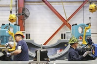 This undated image provided by GE Vernova shows two workers assembling key wind turbine components at the GE Vernova manufacturing facility in Pensacola, Florida. The company has received a record order for 674 turbines that will be used for the SunZia Wind Project in central New Mexico, which is expected to be the largest wind farm in the Western Hemisphere when it comes online in 2026. (Rebecca Shurtleff/GE Vernova via AP)