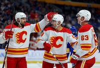 Oct 19, 2023; Buffalo, New York, USA;  Calgary Flames center Adam Ruzicka (63) celebrates his goal with teammates during the third period against the Buffalo Sabres at KeyBank Center. Mandatory Credit: Timothy T. Ludwig-USA TODAY Sports