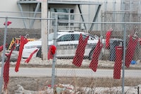 Red dresses, hung in honour of missing and murdered Indigenous women, girls and two-spirit individuals, line fences at Brady Road Resource Management Facility, where the body of 33-year-old Linda Mary Beardy of Lake St. Martin First Nation was discovered, in Winnipeg, Manitoba, Canada, April 4, 2023.  REUTERS/Shannon VanRaes