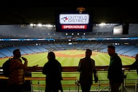 People hang out at the Corona Rooftop Patio during a tour of the Snew renovations completed to the Rogers Centre stadium, home of the Toronto Blue Jays, in Toronto, Thursday, April 6, 2023. THE CANADIAN PRESS/Cole Burston