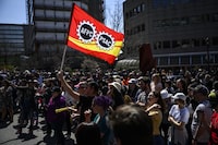 Members of the Public Service Alliance of Canada (PSAC) watch a performance as they picket outside Place du Portage in Gatineau, Que., on Friday, April 28, 2023. THE CANADIAN PRESS/Justin Tang