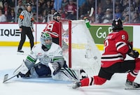 Quebec Remparts' Theo Rochette, front right, scores his second goal against Seattle Thunderbirds goalie Thomas Milic, as Quebec's Mikael Huchette, back, watches during third period Memorial Cup hockey action, in Kamloops, B.C., on Monday, May 29, 2023. THE CANADIAN PRESS/Darryl Dyck
