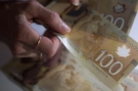 Lower interest rates are coming for some of the most expensive forms of debt as the federal government pushes forward on its promise to take action against so-called predatory loans. Canadian $100 bills are counted in Toronto on Tuesday, Feb. 2, 2016. THE CANADIAN PRESS/Graeme Roy