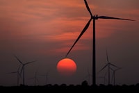FILE - The sun sets at wind farm in McCook, Texas during a heat wave on July 20, 2022. Both sides of the political spectrum have their say about ESG: It’s either just a label that costs more, or it’s saving the world. Environmental, social and corporate governance criteria are factors for evaluating investments and companies, but have those criteria created any change? (Delcia Lopez/The Monitor via AP, File)