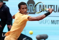 Canada's Felix Auger-Aliassime returns the ball to Norway's Casper Ruud during the 2024 ATP Tour Madrid Open tournament round of 16 tennis match at Caja Magica in Madrid on April 30, 2024. (Photo by Thomas COEX / AFP) (Photo by THOMAS COEX/AFP via Getty Images)