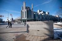 A concrete sign with Queen's University engraved on it sits at the corner of Union St. and University Ave.. on the campus of Queen's University in Kingston, Ont., is photographed on Jan 20 2021. The Joseph S. Stauffer Library is the building across the street.