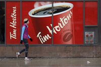 Signage for Tim Hortons is seen outside a Tim Hortons restaurant in Toronto on March 6, 2020.