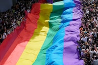 FILE - Participants hold a rainbow flag during a Pride Parade in Bangkok, Thailand, on June 4, 2023. Thailand’s Cabinet on Tuesday, Nov. 21, approved an amendment to its civil code to allow same-sex marriage, with an expectation for the draft to be submitted to Parliament next month. (AP Photo/Sakchai Lalit, File)