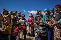 LHOKHA, CHINA - APRIL 26:  Tibetan women and children in a village near the Yamdrok Lake on April 26, 2017 in Dongla County in the Lhokha Prefecture of Tibet Autonomous Region, China. Yamdrok Lake is one of the four largest sacred lakes in Tibet. The lake is surrounded by many snow-capped mountains and is fed by numerous small streams.  (Photo by Wang He/Getty Images)