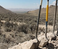 FILE - Exploration drilling continues for Permitting Lithium Nevada Corp.'s Thacker Pass Project on the site between Orovada and Kings Valley, in Humboldt County, Nev., shown beyond a driller's shovels in the distance, Sept. 13, 2018. On Wednesday, March 1, 2023, a federal appeals court cleared the way for construction in Nevada of the largest lithium mine in the U.S. while it considers claims by conservationists and tribes that the government illegally approved it in a rush to produce raw materials for electric vehicle batteries. (Suzanne Featherston/The Daily Free Press via AP)