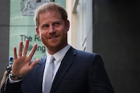 (FILES) Britain's Prince Harry, Duke of Sussex, waves as he leaves the Royal Courts of Justice, Britain's High Court, in central London on June 7, 2023. Prince Harry has dropped his defamation proceedings against the publishing company of the British tabloid Mail on Sunday, which he had attacked over an article relating to his police protection when he visits the United Kingdom, the publication announced on Friday, January 19. (Photo by Adrian DENNIS / AFP) (Photo by ADRIAN DENNIS/AFP via Getty Images)