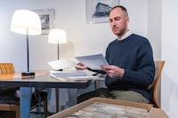 Jamie Jelinski, an art historian and tattoo researcher, looks through a large stack of redacted documents including documents that show the skull of 1922 murder victim Raoul Delorme, in Montreal on Thursday, November 16, 2023. Jelinski has been engaged in a lengthy struggle for access to information, facing denials from Quebec officials regarding photographs and documents of a forensics collection of human remains publicly exhibited as recently as four years ago. Evan Buhler/The Globe and Mail