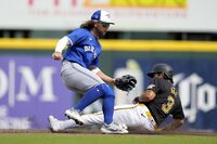Pittsburgh Pirates' Ji Hwan Bae steals second base as Toronto Blue Jays shortstop Bo Bichette, left, waits for the throw in the third inning of a spring training baseball game Tuesday, March 5, 2024, in Bradenton, Fla. (AP Photo/Charlie Neibergall)