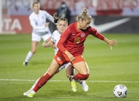 Canada’s Janine Beckie, right, breaks away from New Zealand’s Olivia Chance during first half Celebration Tour soccer action in Montreal, Tuesday, October 26, 2021. THE CANADIAN PRESS/Graham Hughes  
