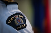 Police in British Columbia say two suspects in Nigeria have been arrested over the sextortion of a B-C boy who died last year. An RCMP patch is seen on a shoulder in Surrey, B.C., on Friday, April 28, 2023. THE CANADIAN PRESS/Darryl Dyck