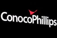 FILE PHOTO: A screen displays the logo for ConocoPhillips on the floor of the New York Stock Exchange (NYSE) in New York City, U.S., April 6, 2022. REUTERS/Brendan McDermid/File Photo