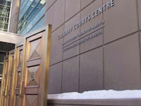 A 20-year old Calgary man has pleaded guilty to one count of facilitating terrorist activity. The sign at the Calgary Courts Centre in Calgary is shown on Friday, Jan. 5, 2018. THE CANADIAN PRESS/Bill Graveland