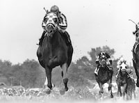 FILE - Jockey Ron Turcotte rides Secretariat during the 99th Kentucky Derby at Churchill Downs in Louisville, Ky. on May 5, 1973.Secretariat won the Derby, Preakness and Belmont in record times that still stand. (AP Photo/Bob Daugherty, File)