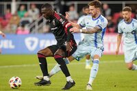 D.C. United forward Christian Benteke, left, competes for the ball against CF Montreal center back Joel Waterman during the second half of an MLS soccer match, Saturday, March 30, 2024, in Washington. (AP Photo/Nathan Howard)