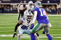 Dallas Cowboys cornerback DaRon Bland (26) defends as Seattle Seahawks wide receiver DK Metcalf (14) runs a route inthe first half of an NFL football game in Arlington, Texas, Thursday, Nov. 30, 2023. (AP Photo/Roger Steinman)
