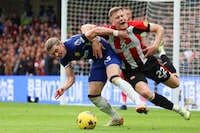 Chelsea's Conor Gallagher, left, duels for the ball with Brentford's Nathan Collins during the English Premier League soccer match between Chelsea and Brentford at Stamford Bridge stadium in London, Saturday, Oct. 28, 2023. (AP Photo/Ian Walton)