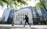 This week, the Bank of Canada hiked interest rates yet again, raising its key interest rate by a quarter of a percentage point to 5 per cent, and the prime rate to 7.2 per cent. A woman walks past the Bank of Canada headquarters in Ottawa, Wednesday, June 1, 2022. THE CANADIAN PRESS/Adrian Wyld