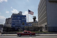 FILE PHOTO: A vintage car used for touristic city tours passes by the U.S. Embassy in Havana, Cuba, November 10, 2021. Photo taken on November 10, 2021. REUTERS/Alexandre Meneghini/File Photo