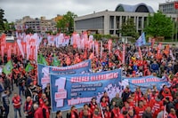 Union members march towards Taksim Square during a May Day (Labour Day) rally, marking International Workers' Day, in Istanbul, on May 1, 2024. Turkish police on May 1, 2024, detained dozens of protesters attempting to tear down barricades in different districts of Istanbul after authorities banned May 1 rallies at the city's main Taksim Square. Tens of thousands of police were deployed across Istanbul, blocking even small sidestreets with metal barriers in an attempt to prevent groups of protesters from gathering. (Photo by Yasin AKGUL / AFP) (Photo by YASIN AKGUL/AFP via Getty Images)
