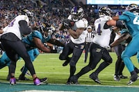 Baltimore Ravens running back Gus Edwards (35) scores a touchdown during an NFL football game against the Jacksonville Jaguars, Sunday, Dec. 17, 2023, in Jacksonville, Fla. The Ravens defeated the Jaguars 23-7. (AP Photo/Gary McCullough)